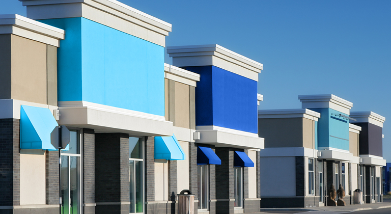 Line of storefronts in shopping center.