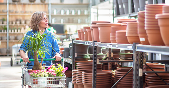 Woman shopping looking at flower pots