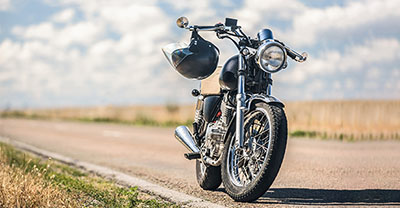 Motorcycle parked on the side of a country road