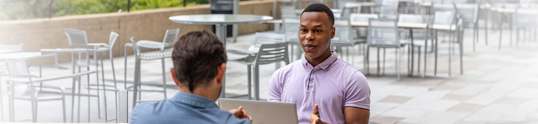 A Sentry intern having a conversation on the patio at the Sentry Insurance home office in Stevens Point.