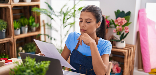 Horticultural employee reading a document at a desk