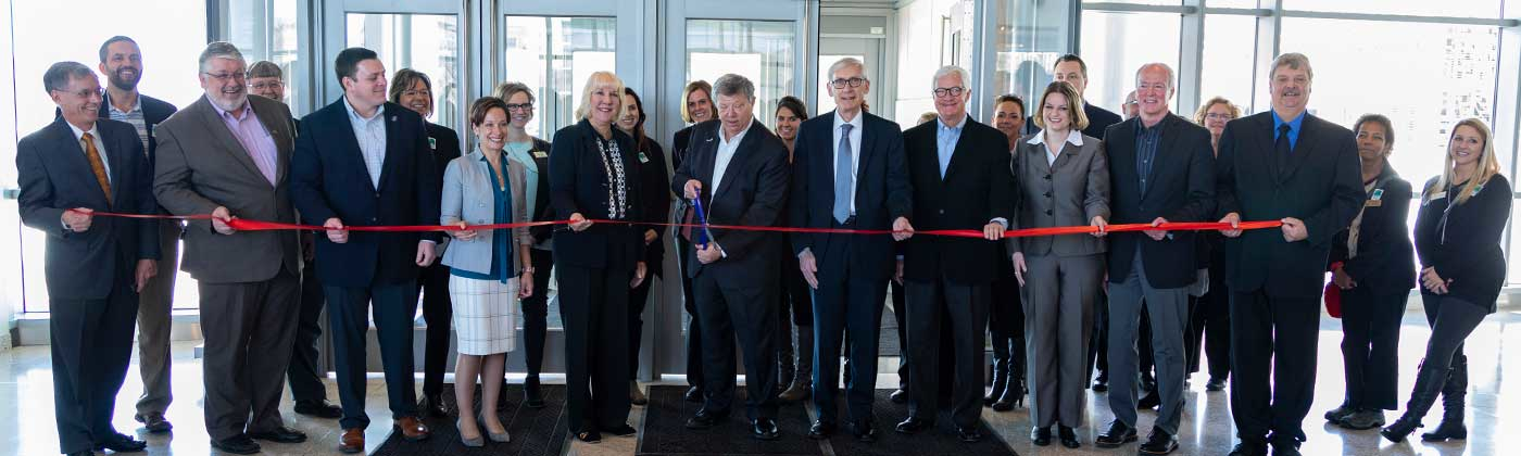 Pete McPartland cutting ribbon for new Sentry building with Tony Evers