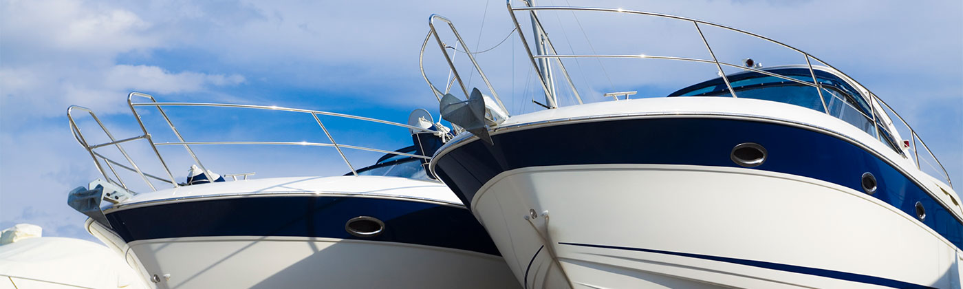 Two boats with a blue sky in background.