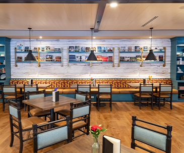 Seating and library books at the Library Cafe