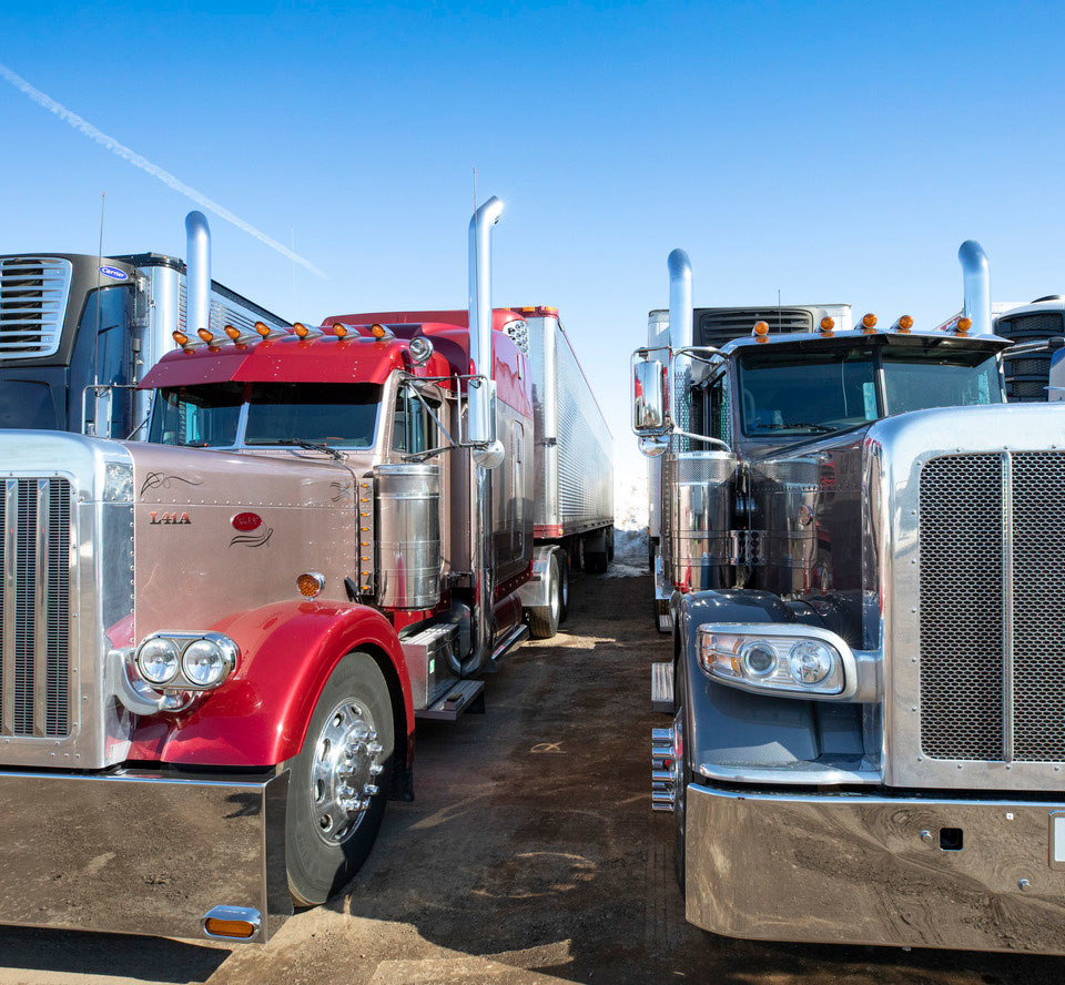 Semi trucks parked near each other.