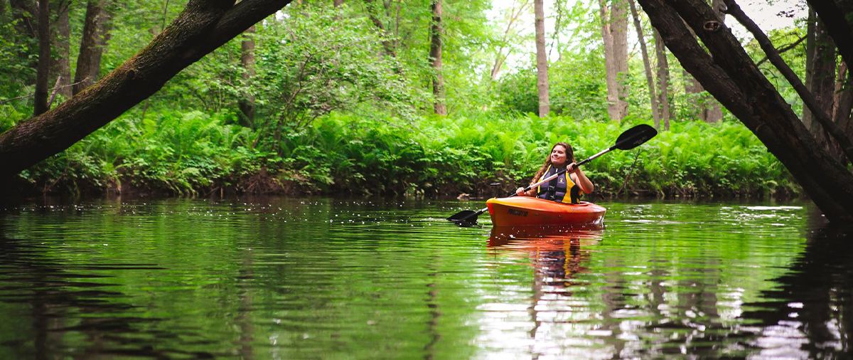 Person kayaking down a river in Stevens Point, WI