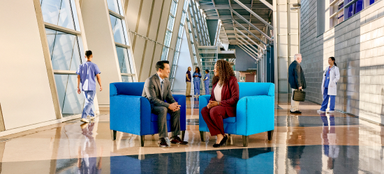 Two healthcare executives in the Sentry blue chairs.