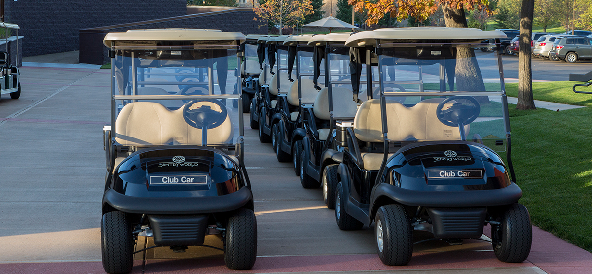 Rows of parked SentryWorld golf carts