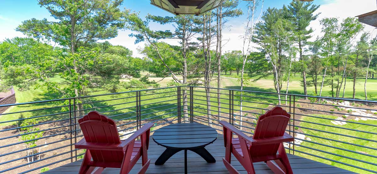 Two outdoor patio chairs and a table on a balcony at The Inn