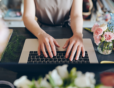 Closeup of someone hands typing on a keyboard