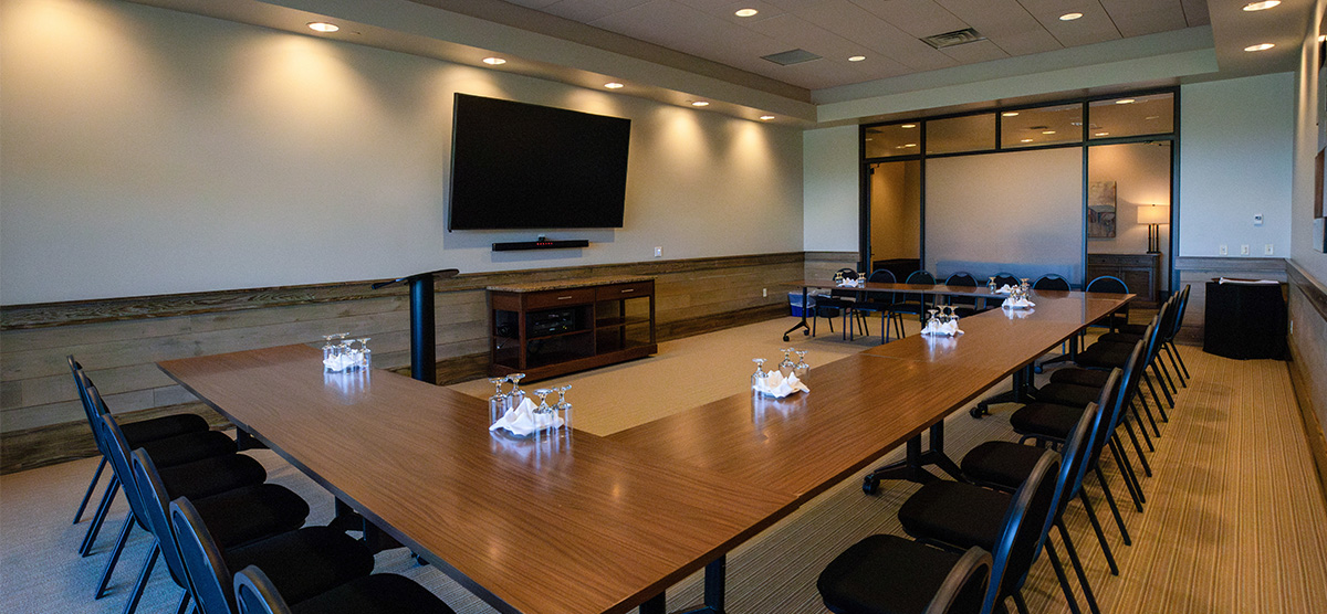 Meeting table and TV in the Community Room at SentryWorld