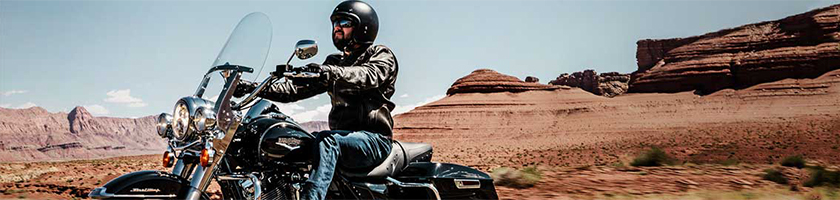 Man riding motorcycle in a desert area