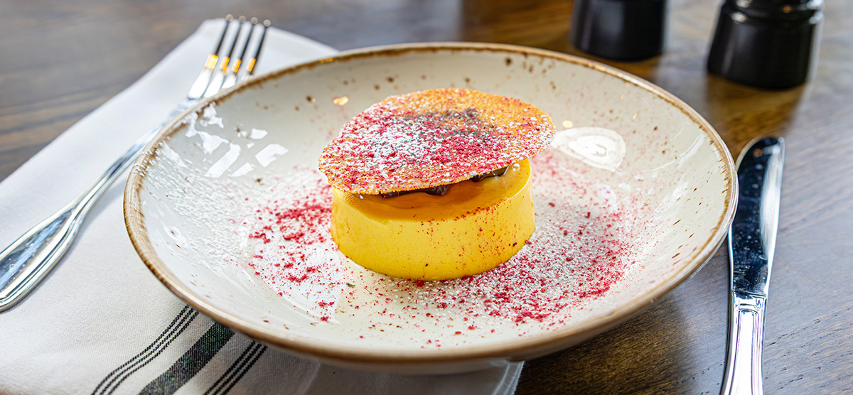 Island Oasis dessert with passion fruit crémeux, coconut caramel, dark chocolate, vanilla gel, and sugar tuille.