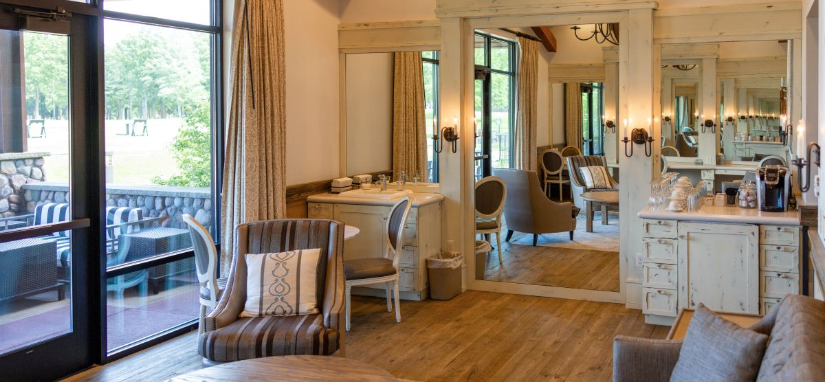 Seating area with doors to the patio at left and a coffee bar to the right. 