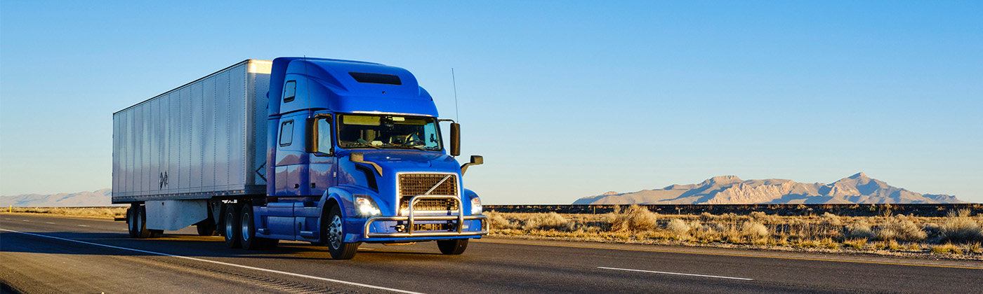 Semi-truck driving down a highway.