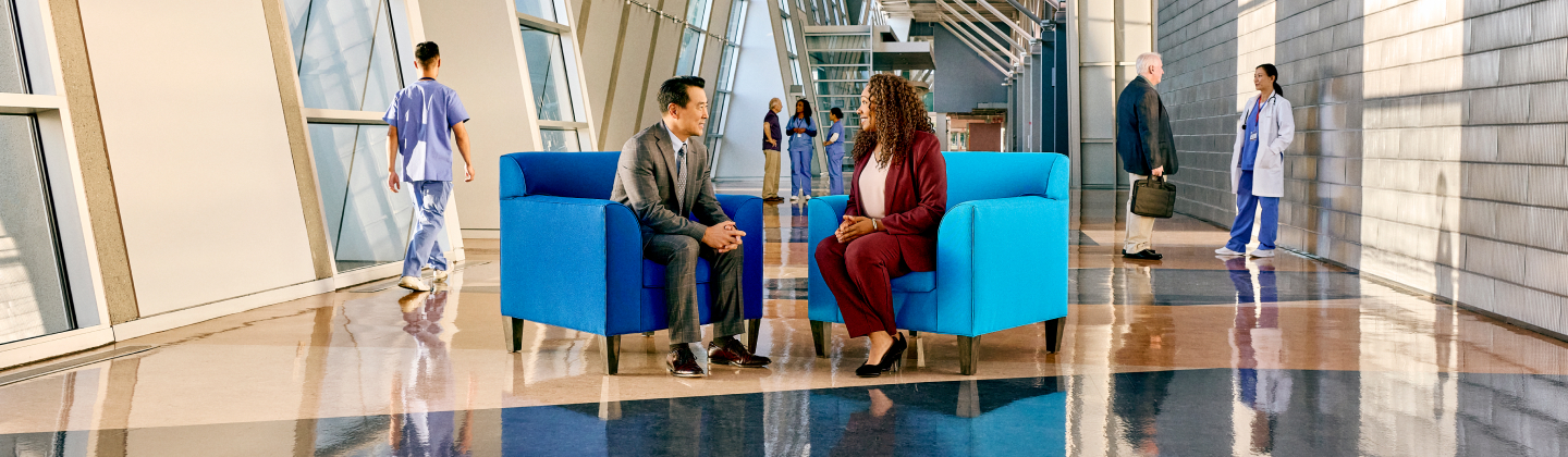 Two healthcare executives sitting in Sentry blue chairs.
