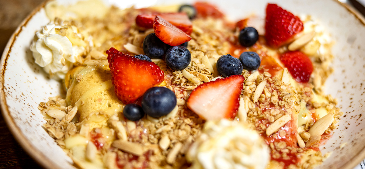 Pancake with granola, whipped cream, and assorted berries at the Library Café