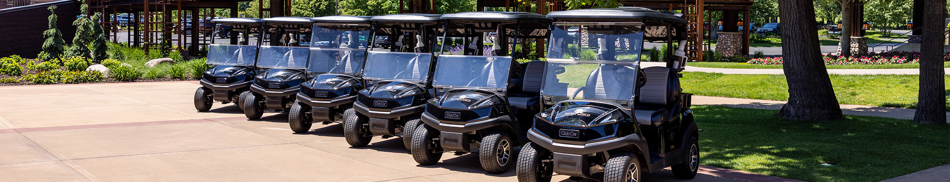 Row of parked SentryWorld golf carts