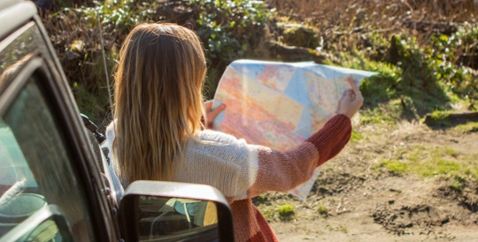 a woman looking at a map