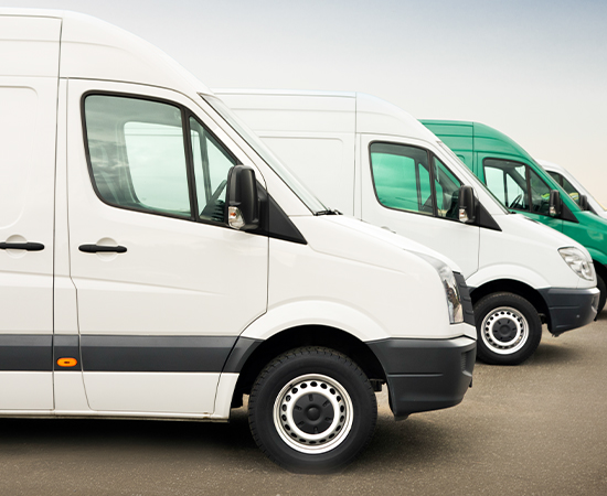 A row of three parked vans