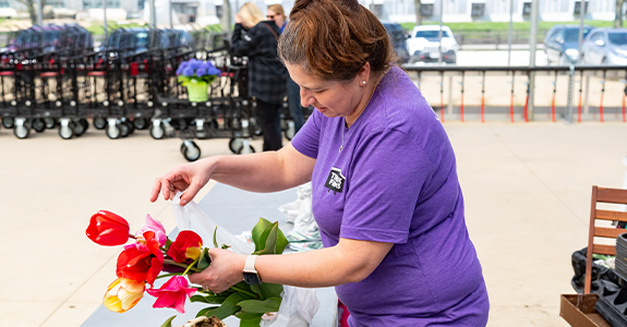 woman bagging up florals for customer