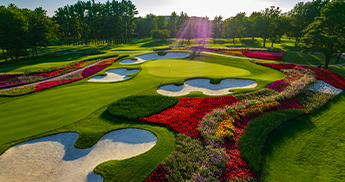 Flowers and sand traps around the 16th hole putting green at SentryWorld