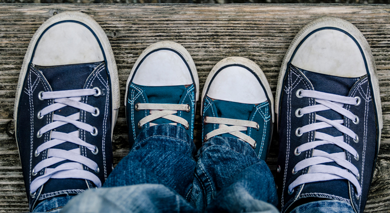 Aerial view of adult and child sneakers