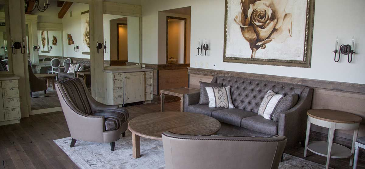 Seating area and large mirror in the Salon at SentryWorld