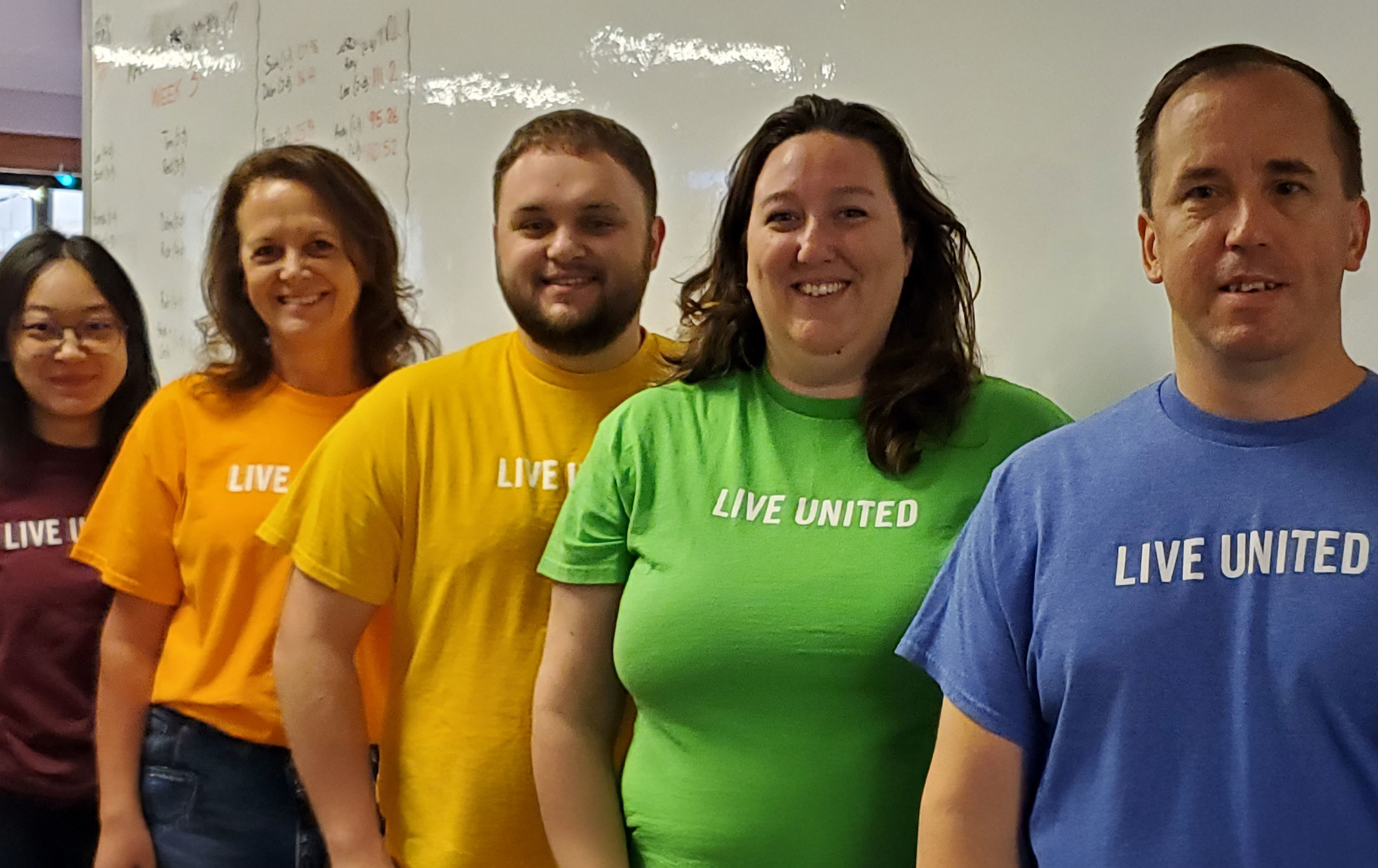 Group photo of associates wearing Live United t-shirts