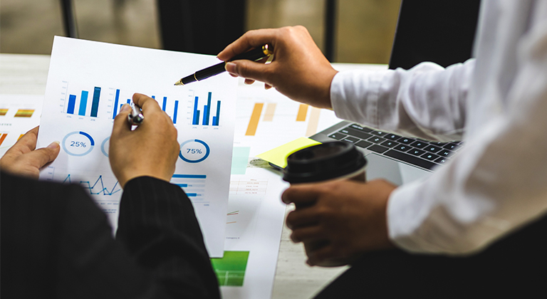 Two people reviewing charts