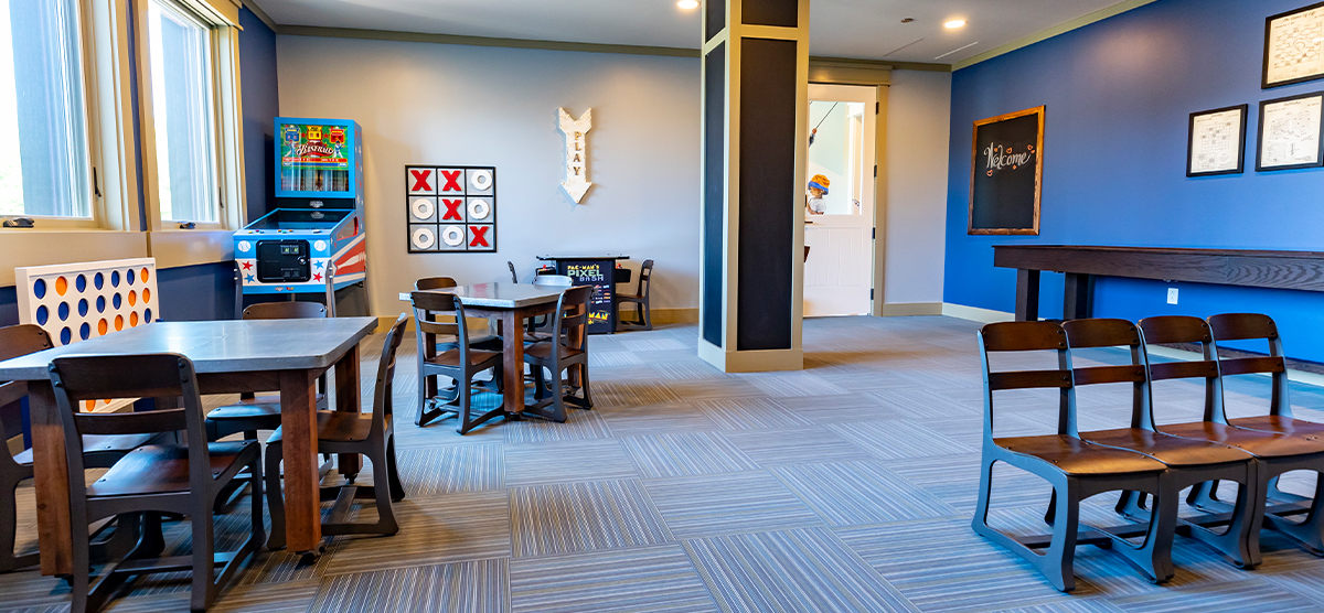 carousel-amenities-kids-club-3-1200x556 The Inn kids club with arcade games and tables.