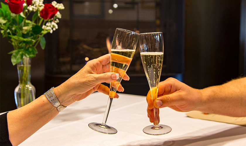 Two people toasting champagne glasses