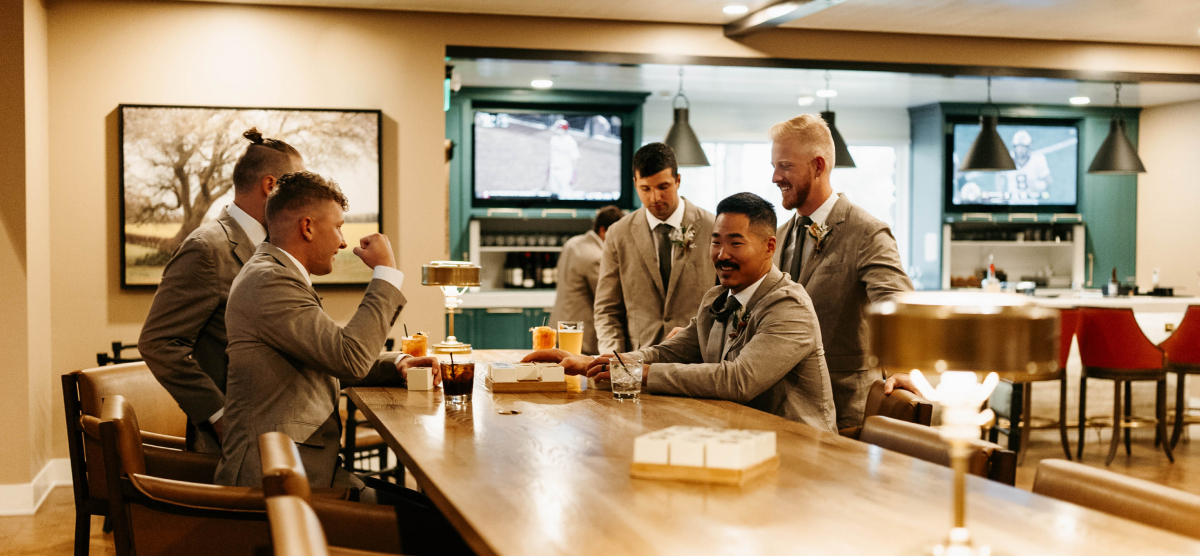 Groomsmen having cocktails in the Library Cafe. 