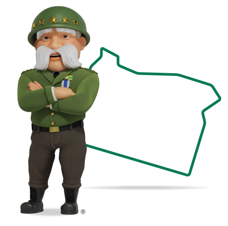 The General standing in front of Oregon with his arms crossed and a smile.