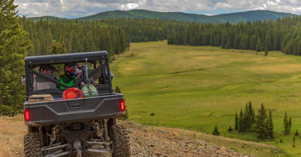Family in ATV overlooking valley