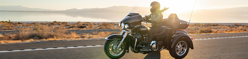 Female motorcyclist riding a trike bike