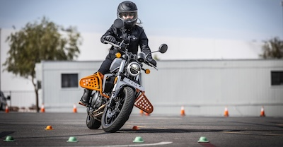 Motorcycle and rider navigating safety course