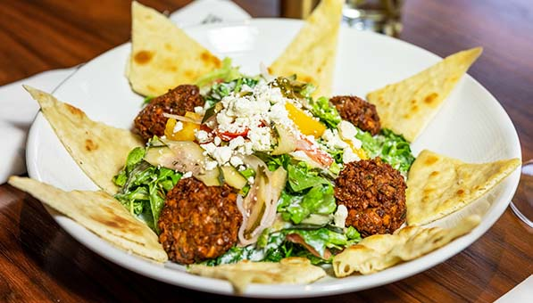 Falafel Salad plated on a table at Muse