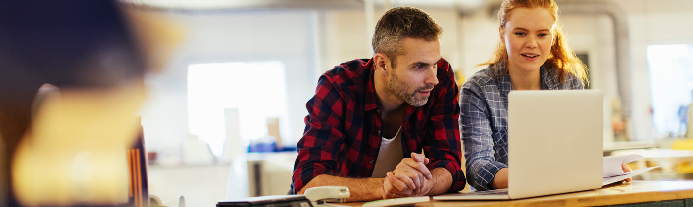 Man and woman looking at laptop at home