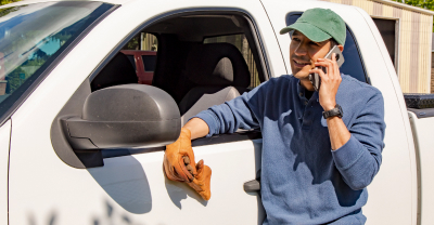 Man on cellphone outside of his truck