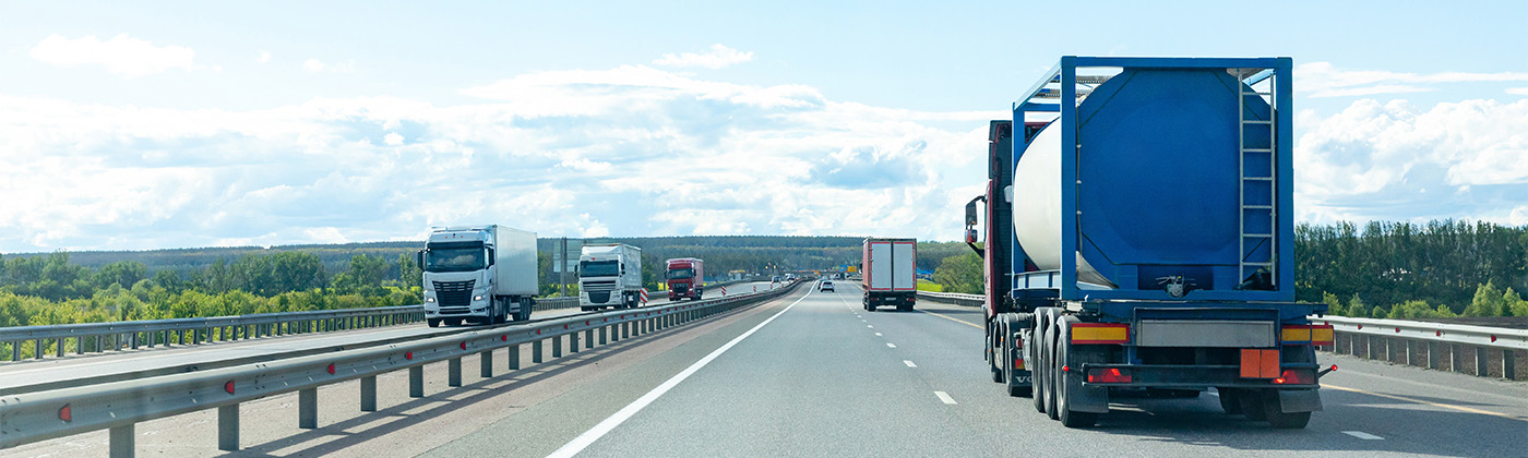Semi trucks driving on a highway.