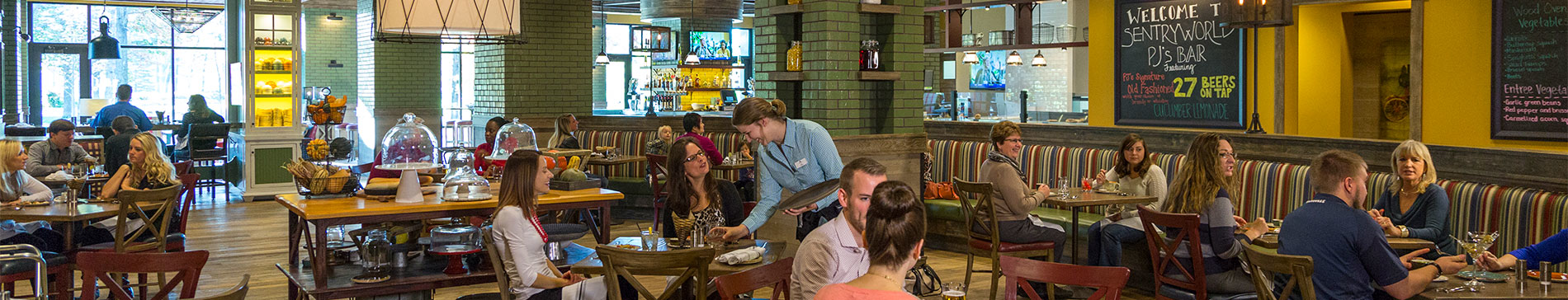 People sitting at tables and being served in the PJ's dining room