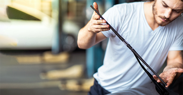 Man replacing a windshield wiper