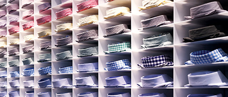 Retail store shelf wall of collared shirts.