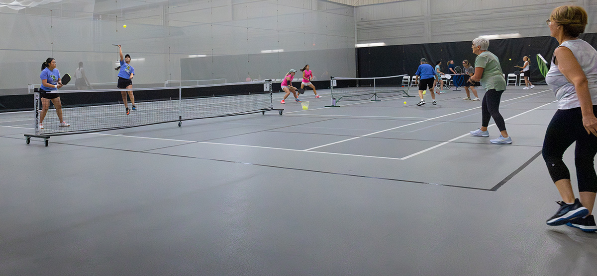 Games of pickleball being played in the SentryWorld field house.