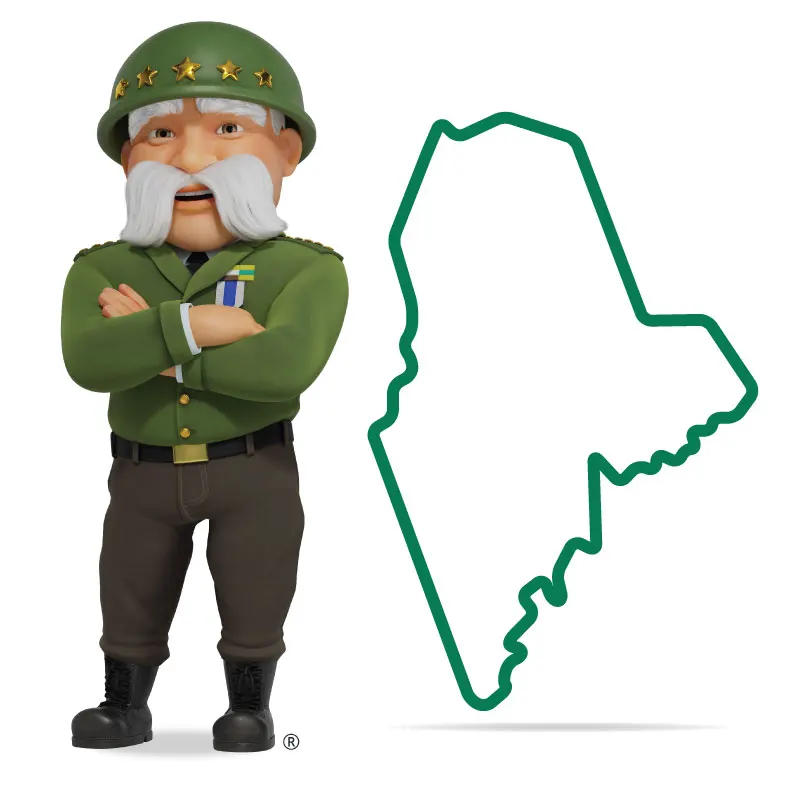 The General standing in front of Maine with his arms crossed and a smile.