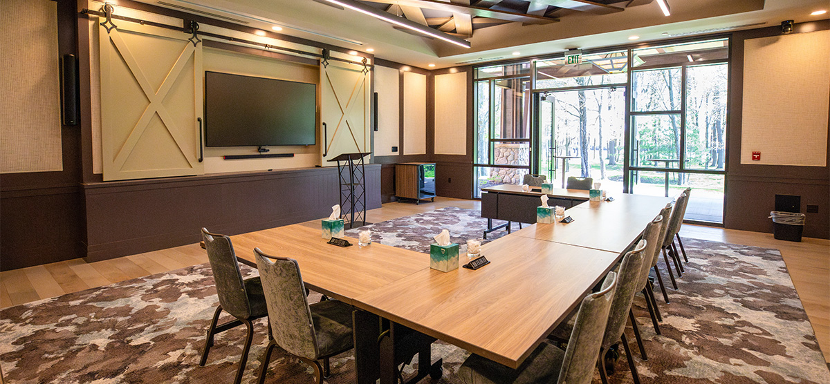 Meeting room with a large table and TV at The Inn at SentryWorld