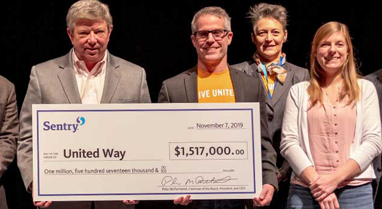 Pete McPartland representative for Sentry donates check to United Way