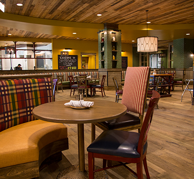 Dining table with a booth and two chairs at PJ's - SentryWorld