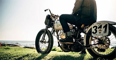 Person sitting on a vintage motorcycle